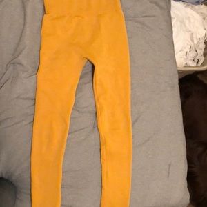 Mustard yellow polyester leggings.